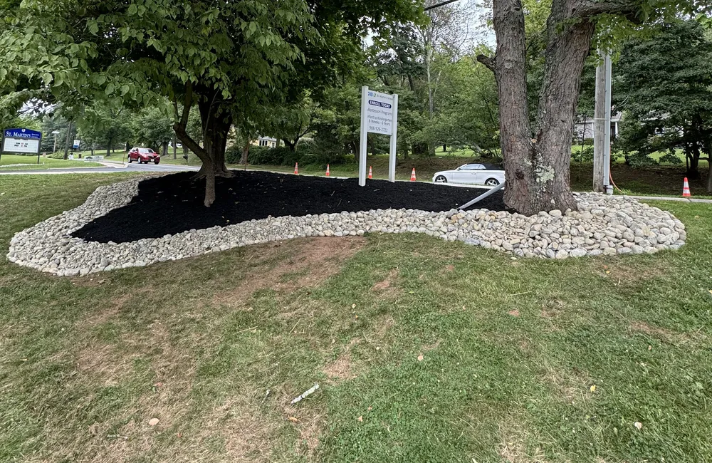 PTB Landscape Management fresh mulch installation with clean stone edging at a commercial property in Somerset County, New Jersey