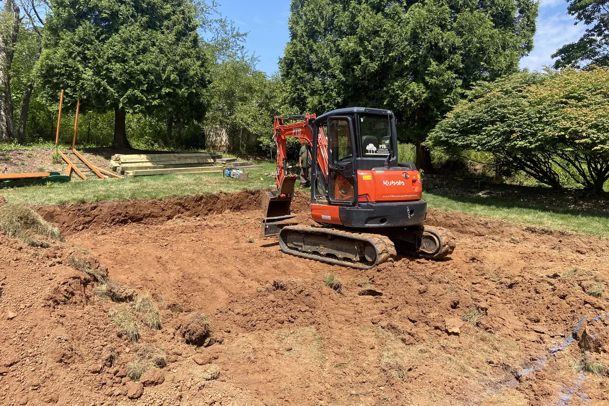 PTB Landscape Management mini excavator clearing and grading a property in Bridgewater NJ