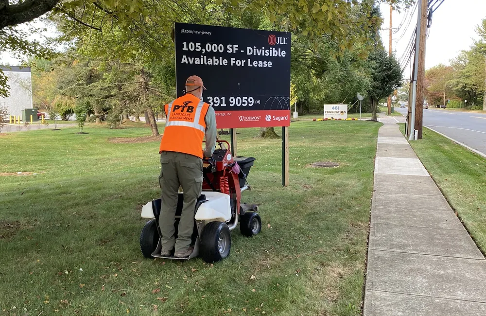 PTB crew applying lawn treatment at a commercial property