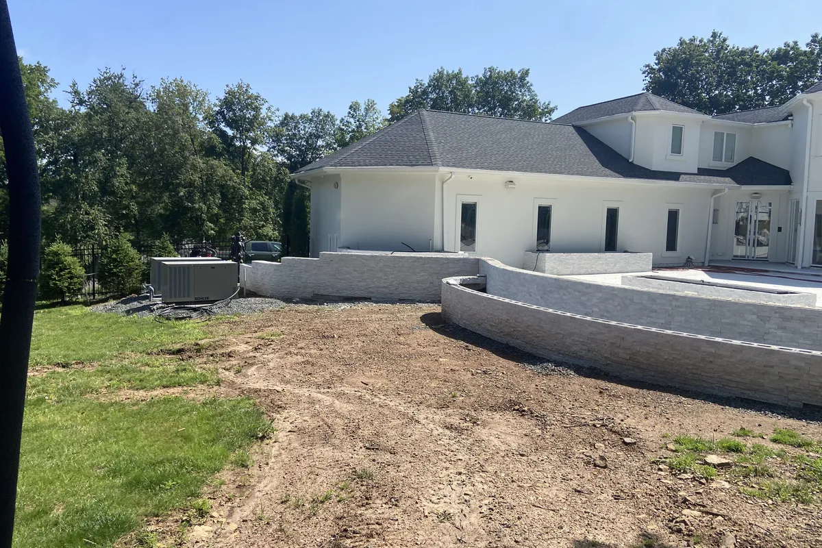 Curved retaining wall and hardscape at a large estate property