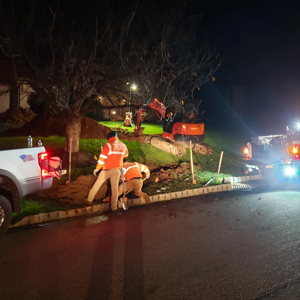 PTB stormwater crew with excavator at night