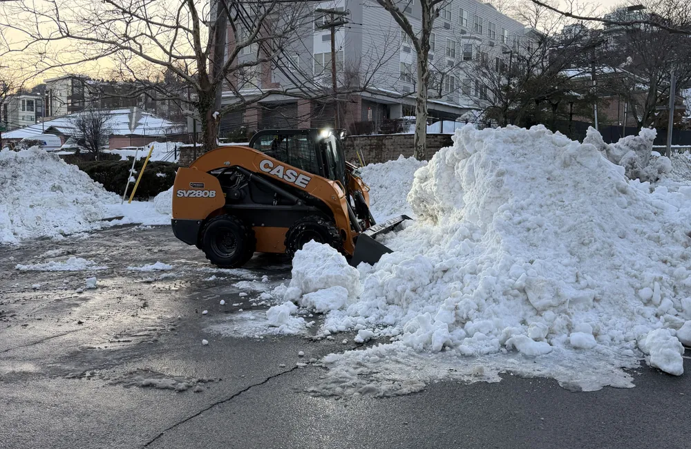 PTB skid steer moving snow at a commercial parking lot in New Jersey